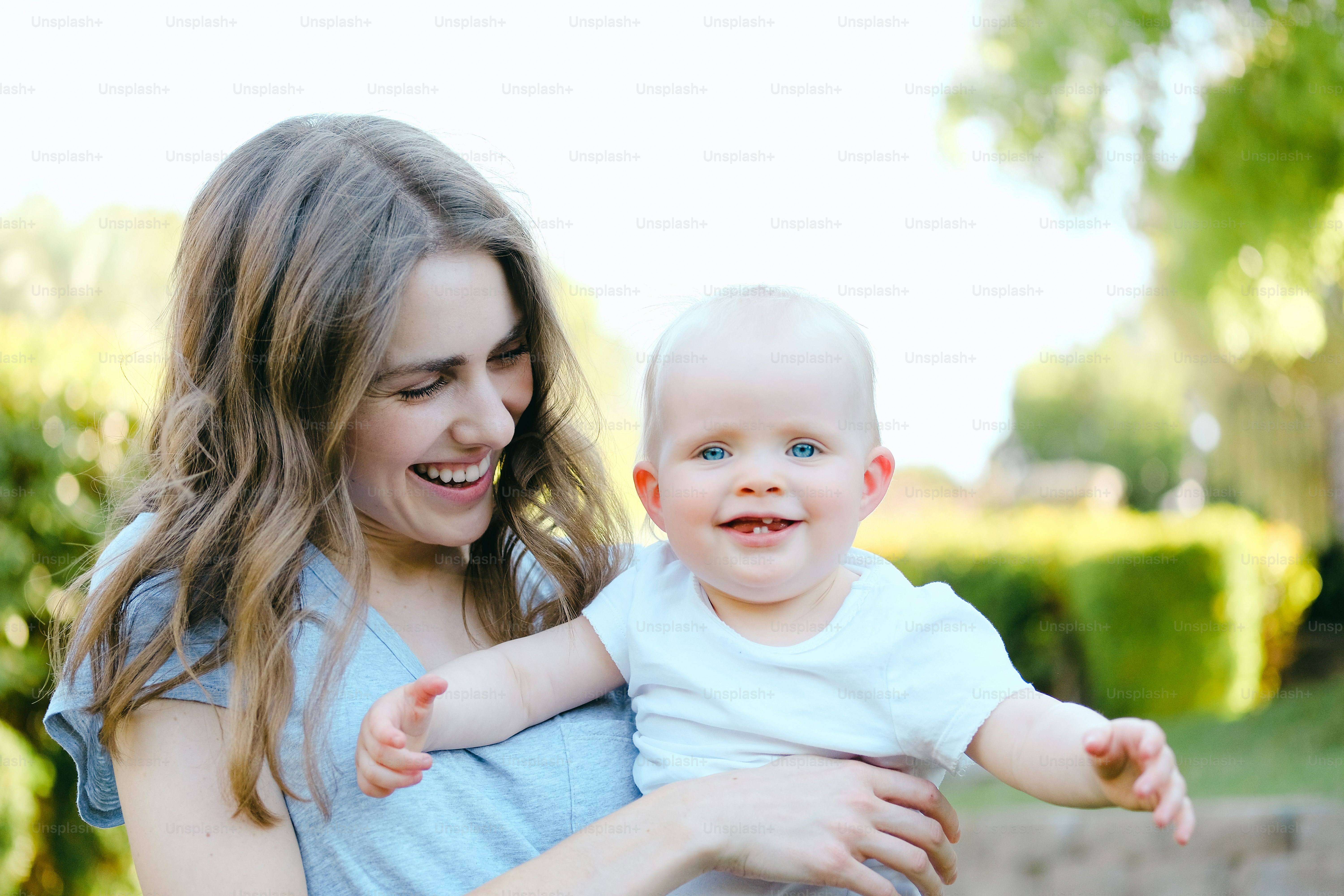 a woman holding a baby in her arms