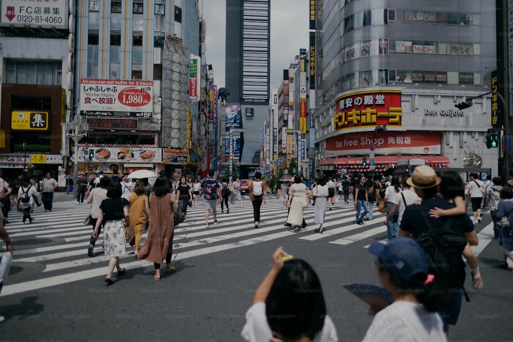 a group of people walking across a street