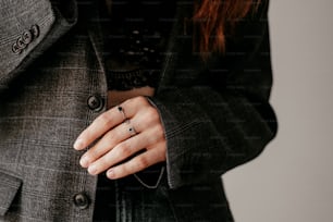 a woman wearing a suit and a ring