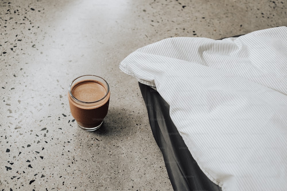 a cup of coffee sitting on top of a table