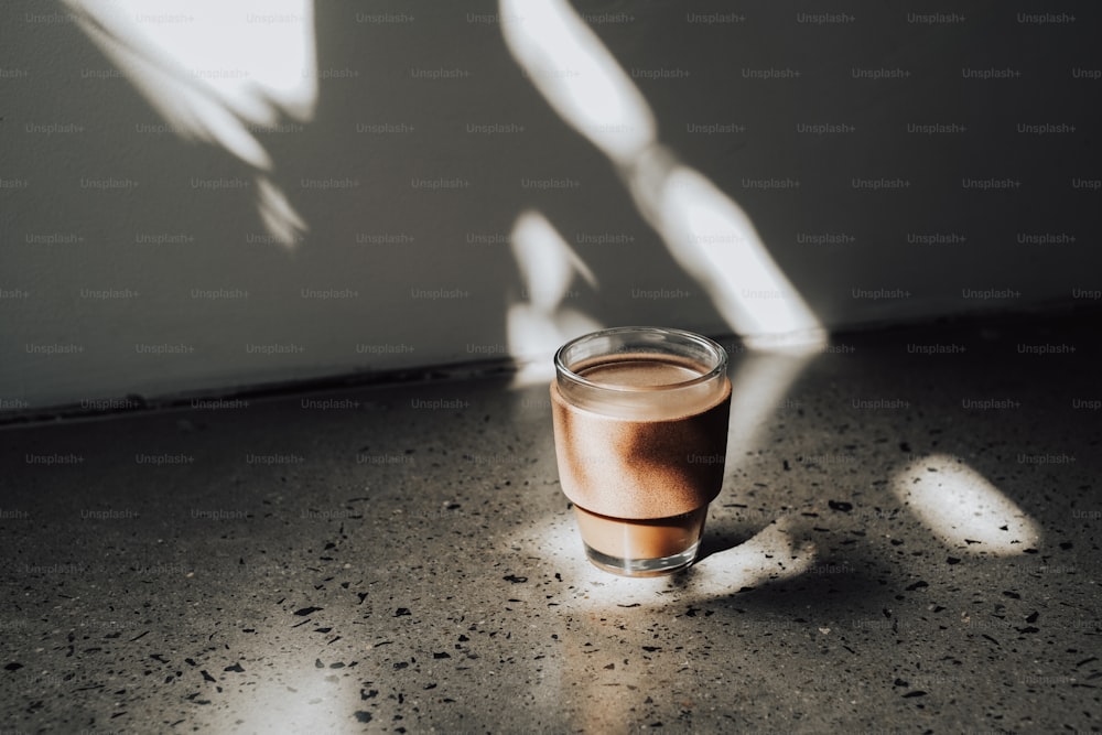 a glass of liquid sitting on a table