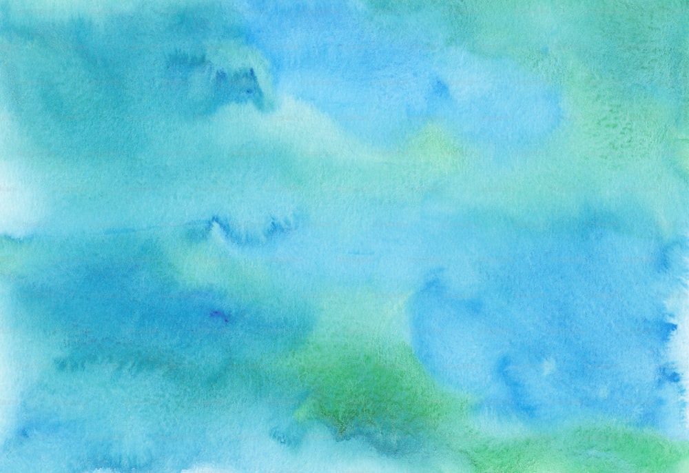 a blue and green watercolor background with white clouds