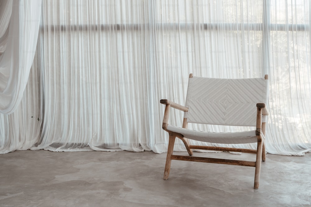 a wooden chair sitting in front of a window