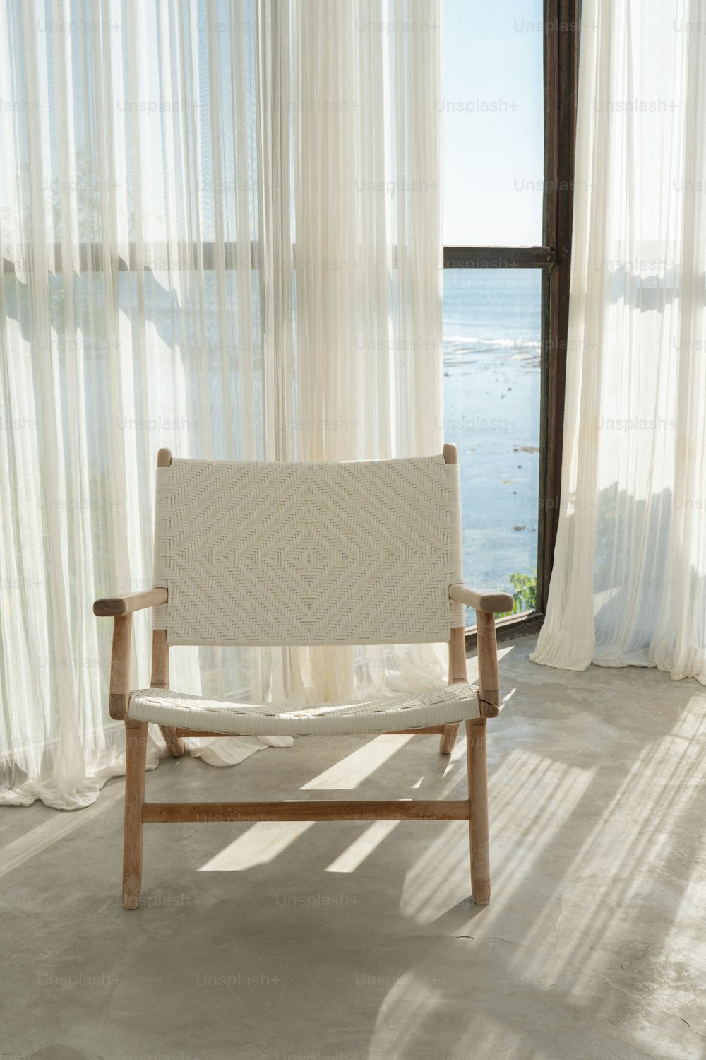 a wooden chair sitting in front of a window