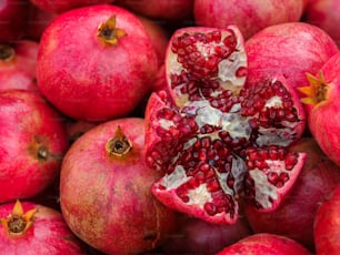 a bunch of pomegranates that have been cut open