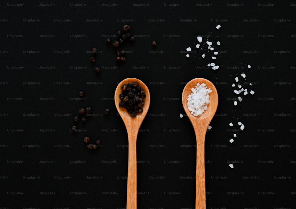 a couple of wooden spoons filled with sea salt