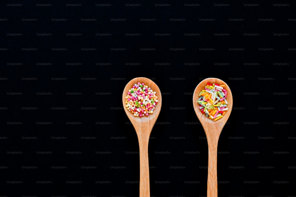 two wooden spoons with sprinkles on them