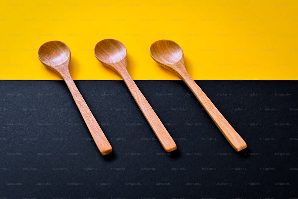 three wooden spoons sitting next to each other