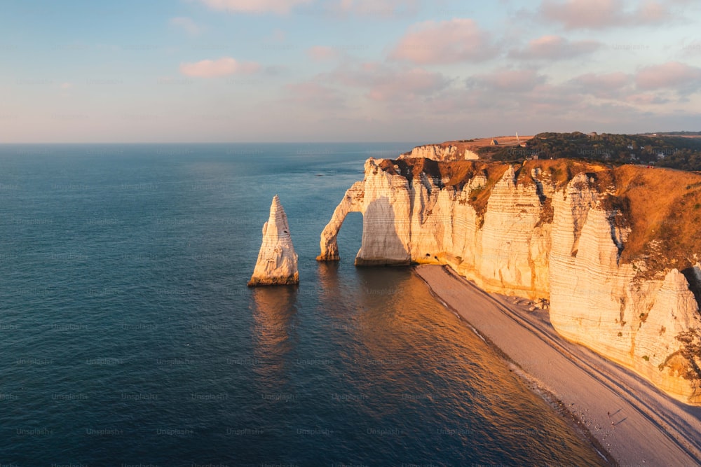 a large body of water next to a rocky cliff