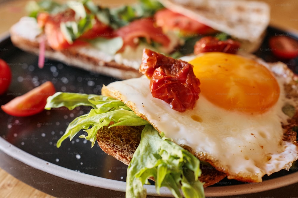 a plate of food with an egg and tomato on it