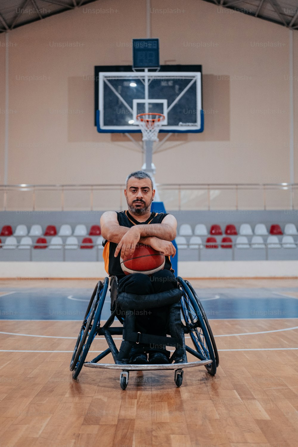 a man in a wheelchair holding a basketball