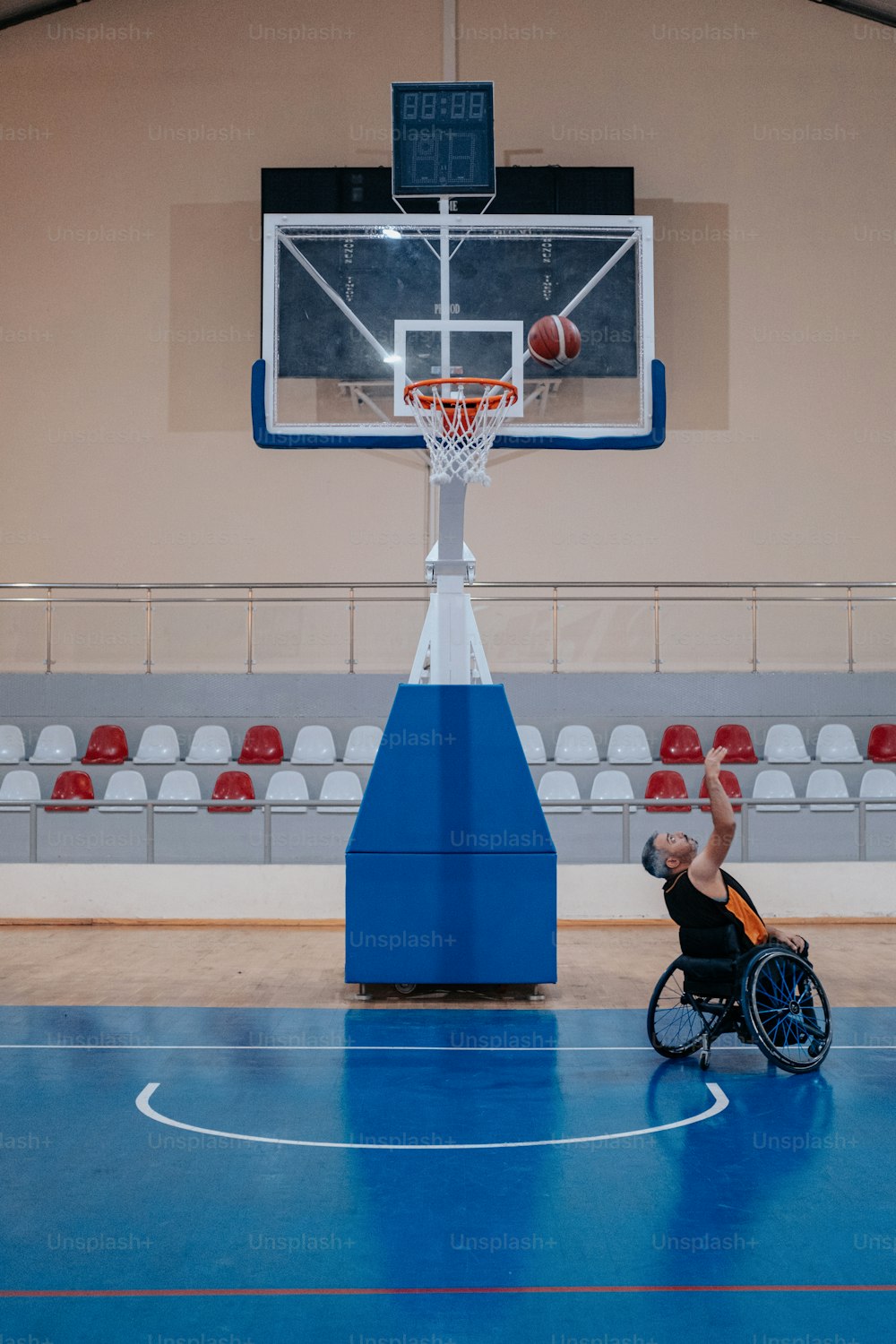 a man in a wheel chair playing basketball