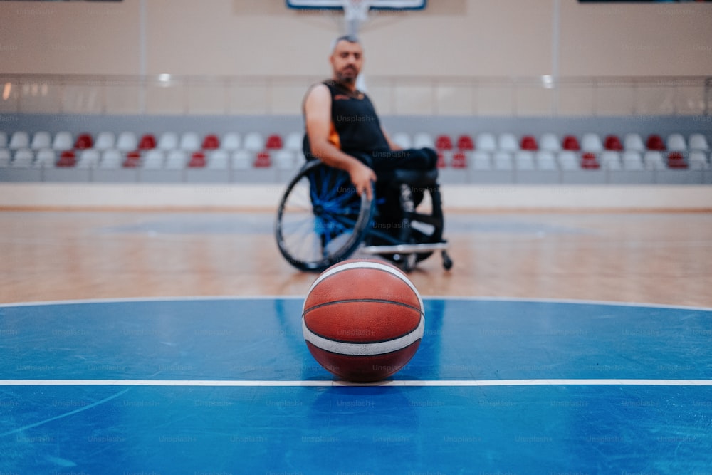 a man in a wheelchair playing basketball on a court