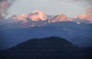 a view of a mountain range with clouds in the sky