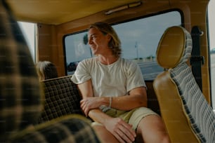 a man sitting on a bus looking out the window