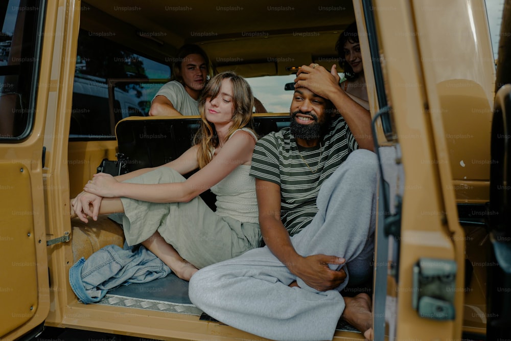a group of people sitting in the back of a van
