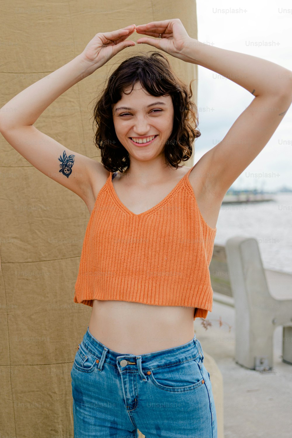 a woman in an orange crop top posing for a picture