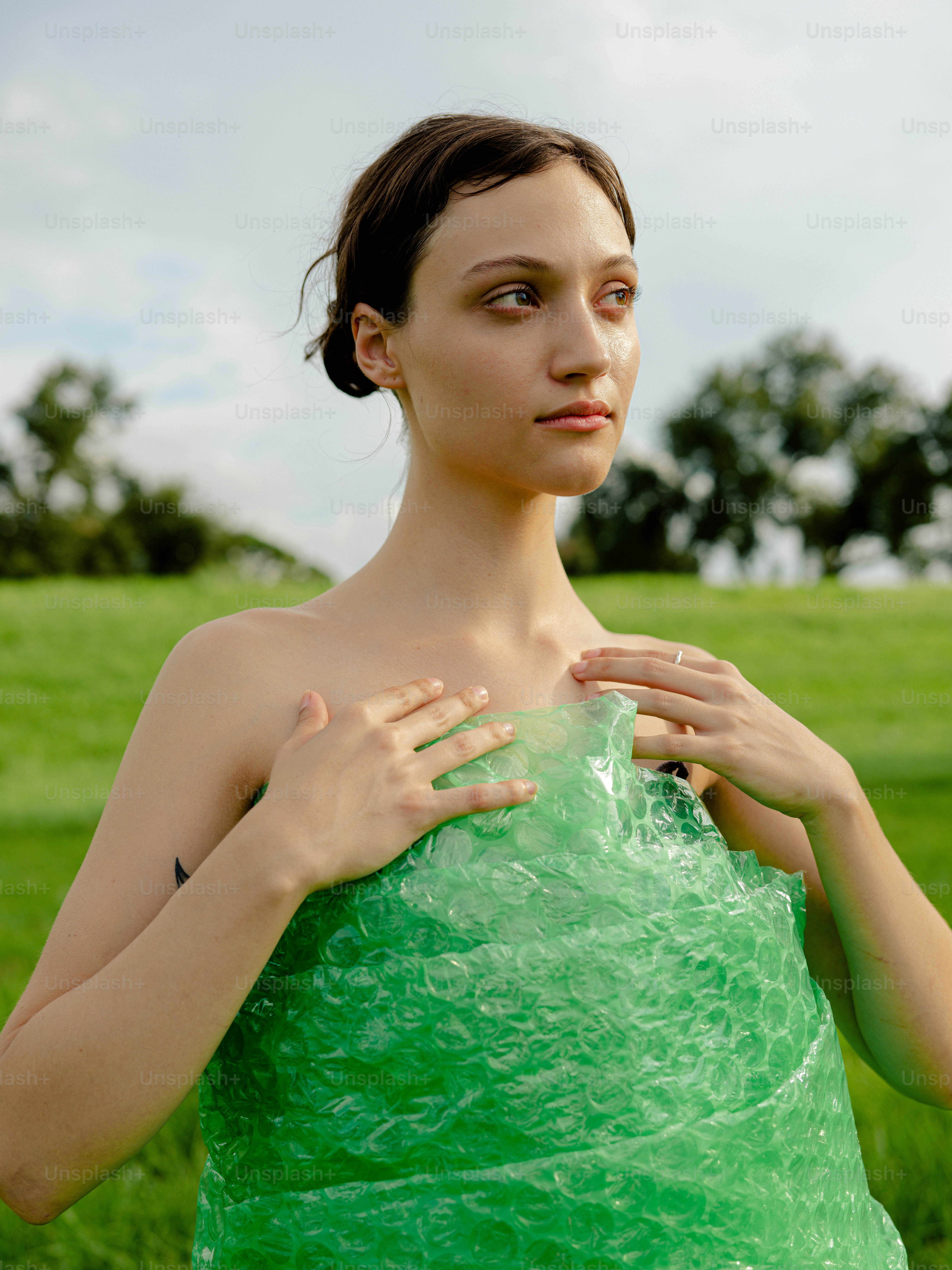 A woman in a green dress standing in a field photo – Dress Image on ...