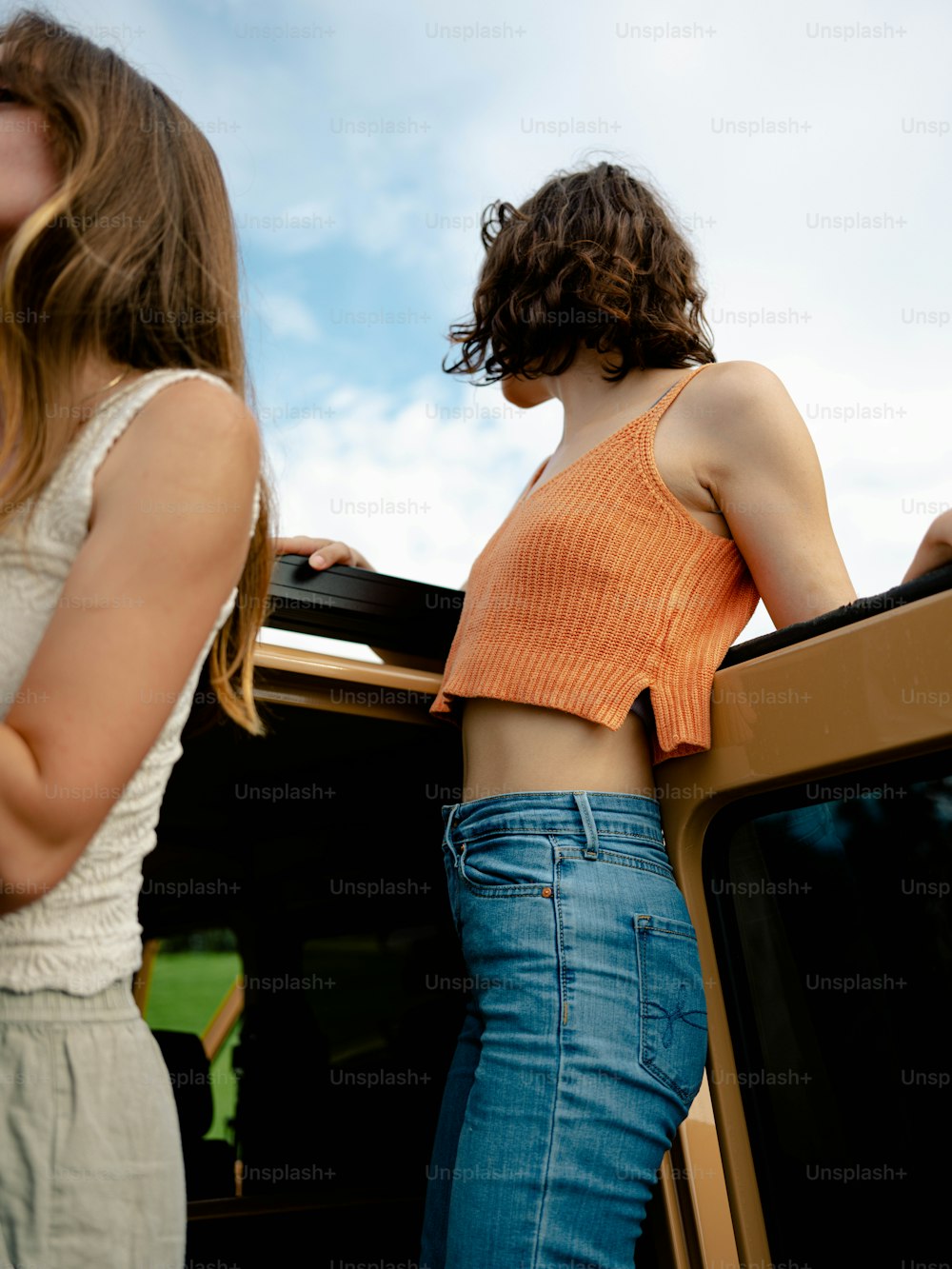 two women standing next to each other near a tv