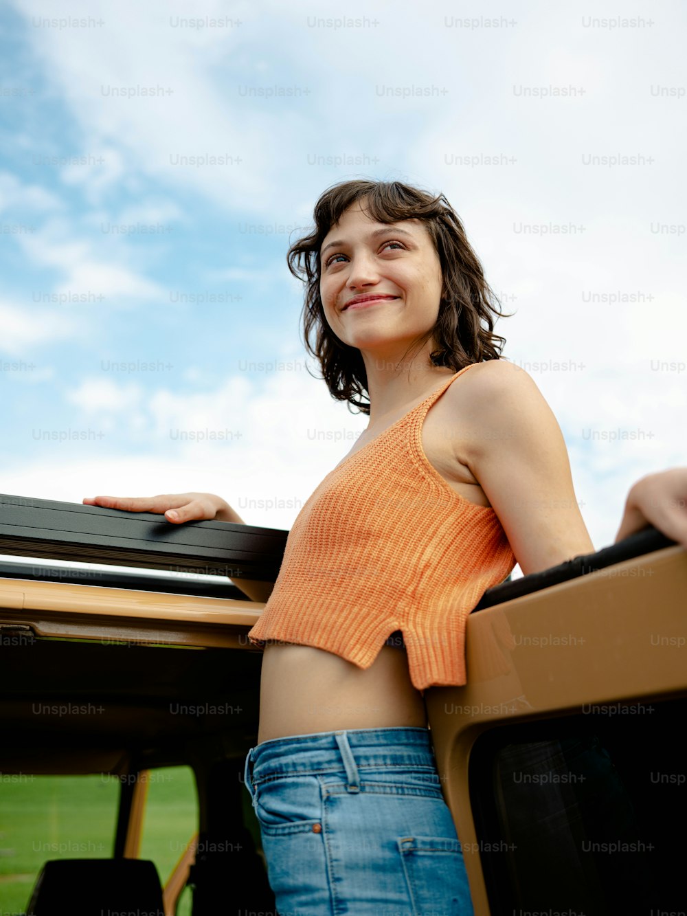 a woman standing in the back of a truck