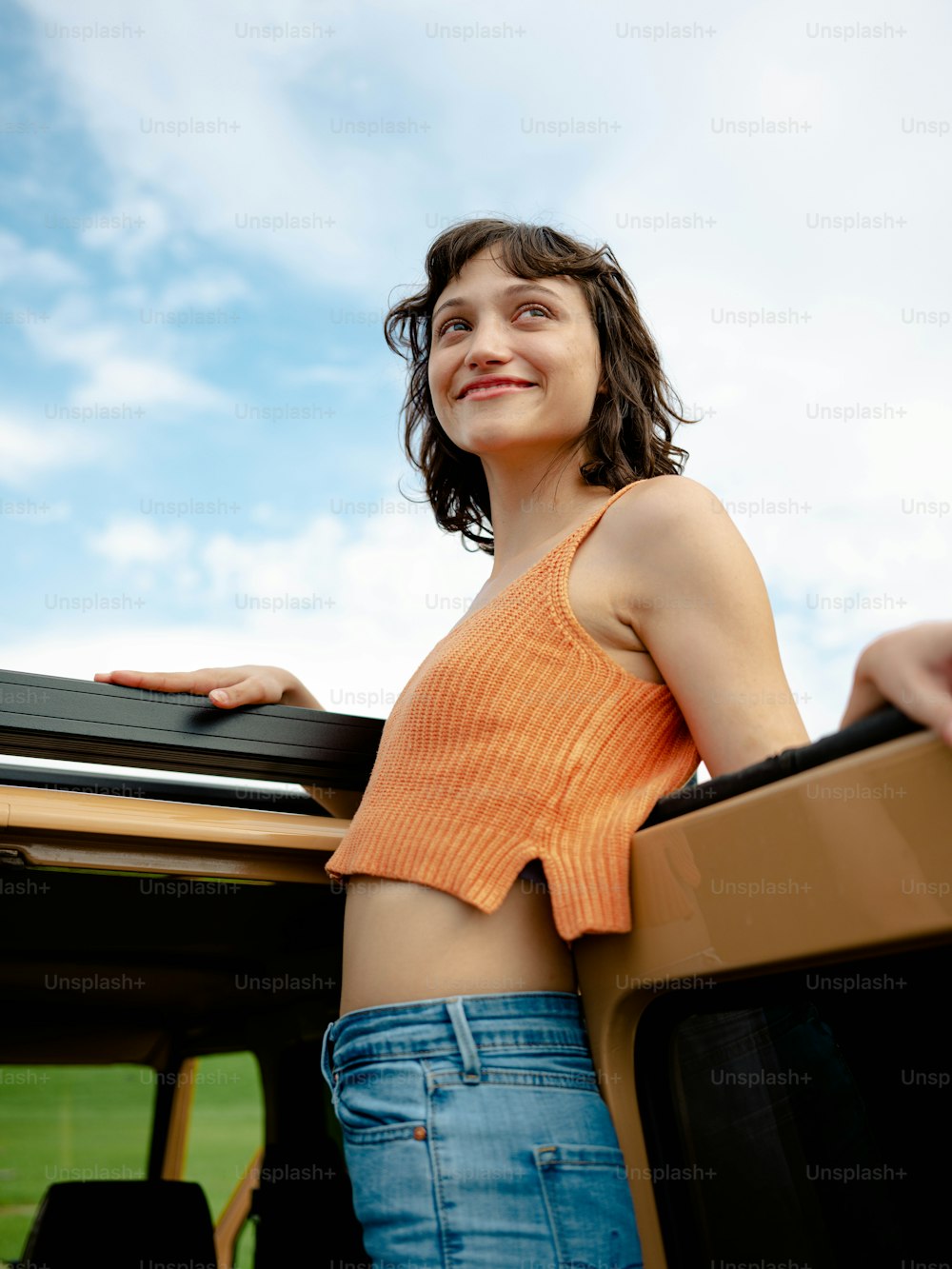 a woman standing in the back of a pick up truck