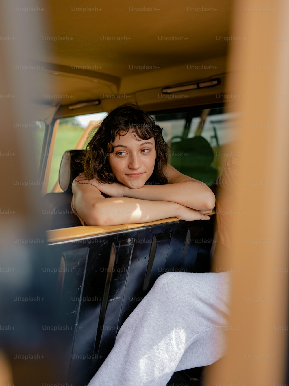 a woman sitting in the back of a truck