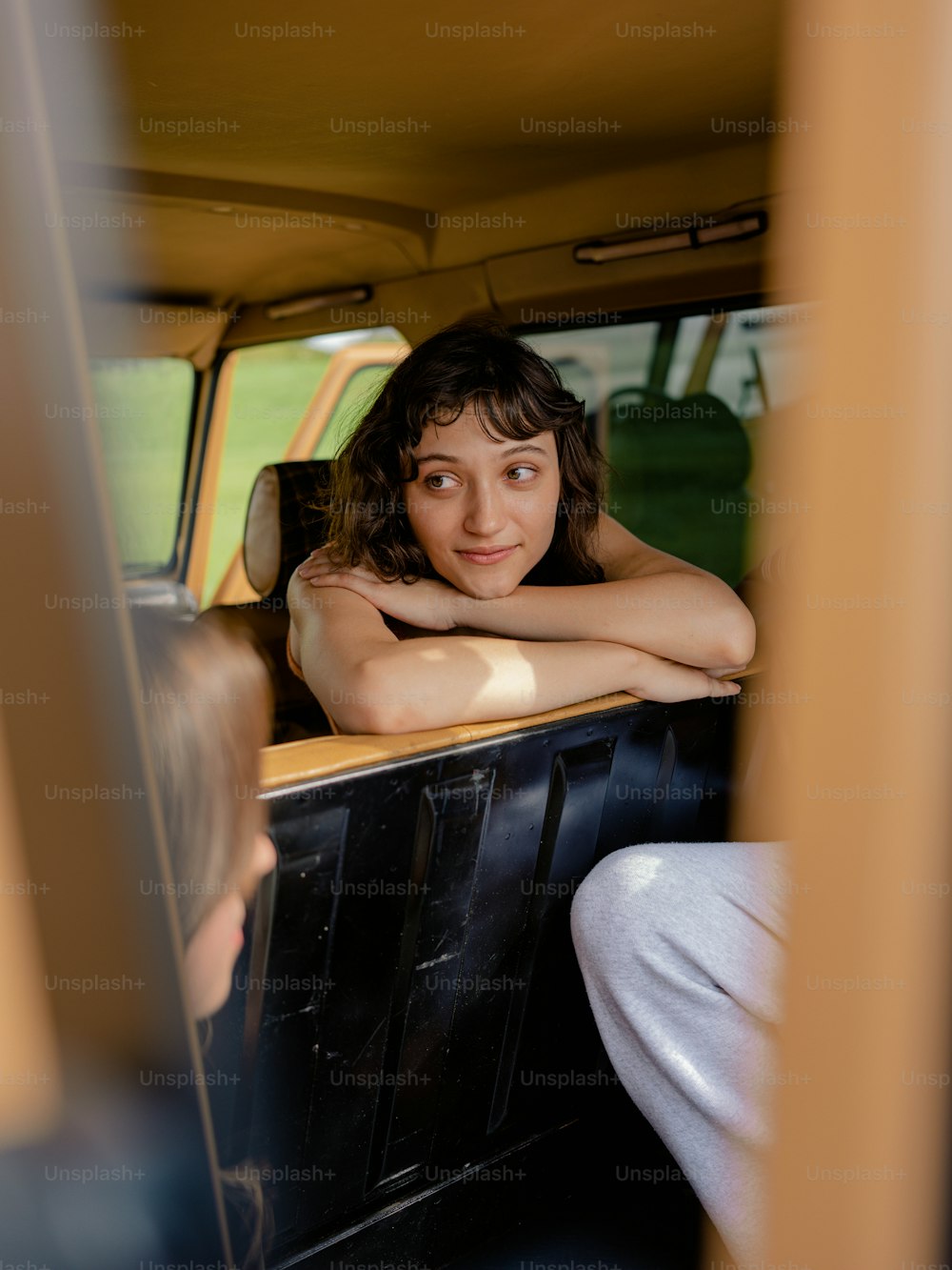 a woman sitting in the back of a truck