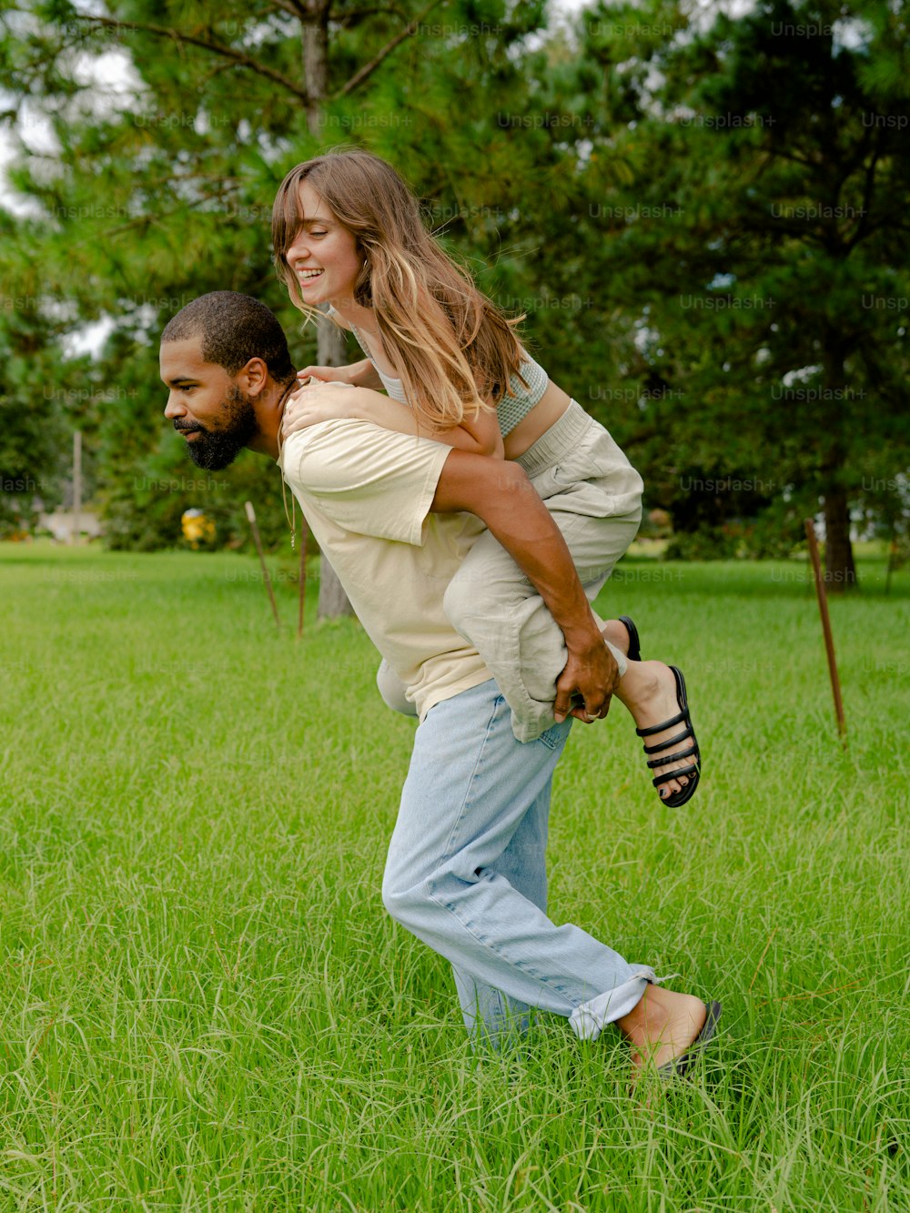 a man carrying a woman on his back in a field