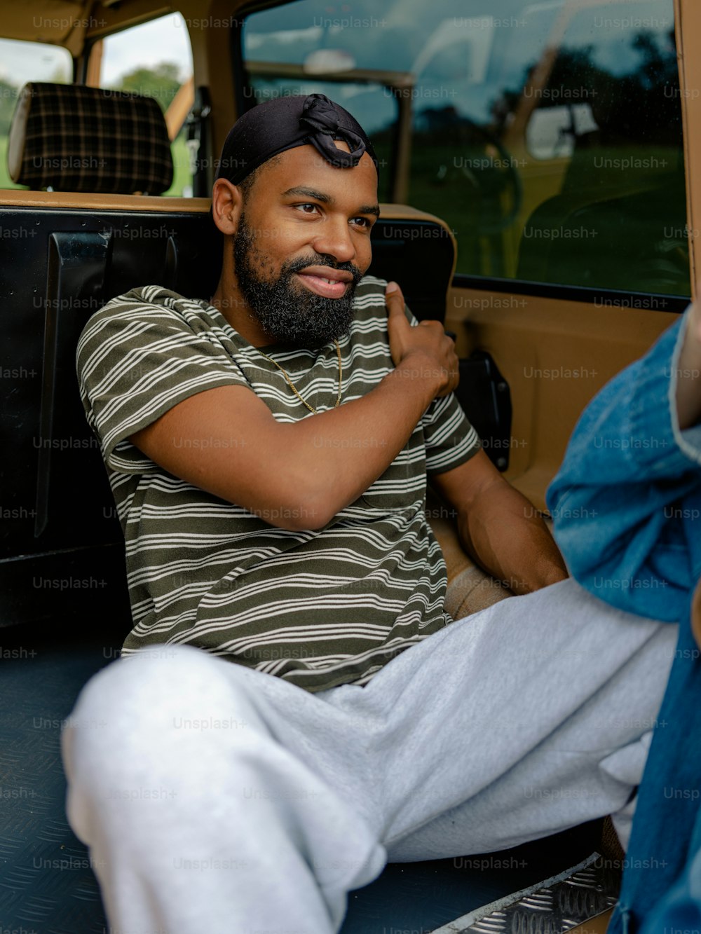 a man sitting in the back of a truck