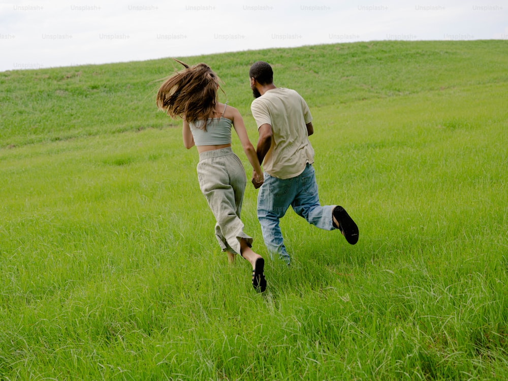 a man and a woman running through a field