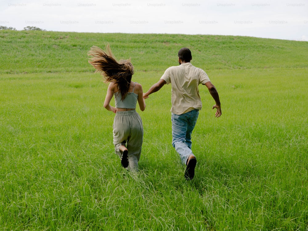 a man and a woman running through a field