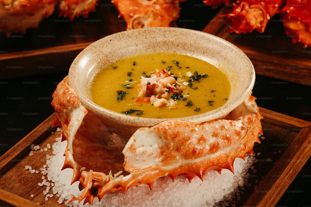 a bowl of soup on a wooden tray