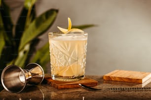 a glass with a lemon wedge on top of it
