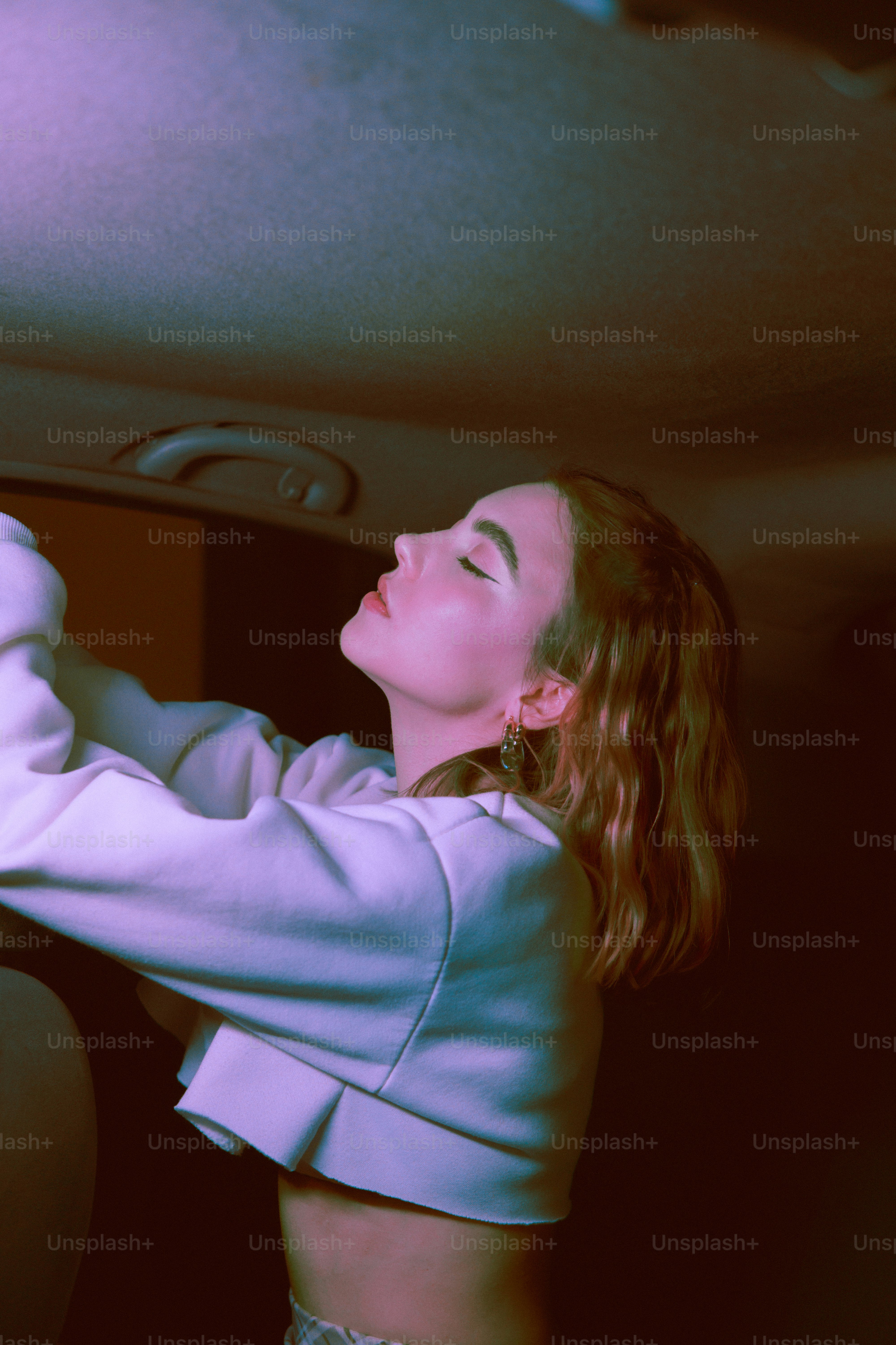 a woman in a white top is holding a cell phone