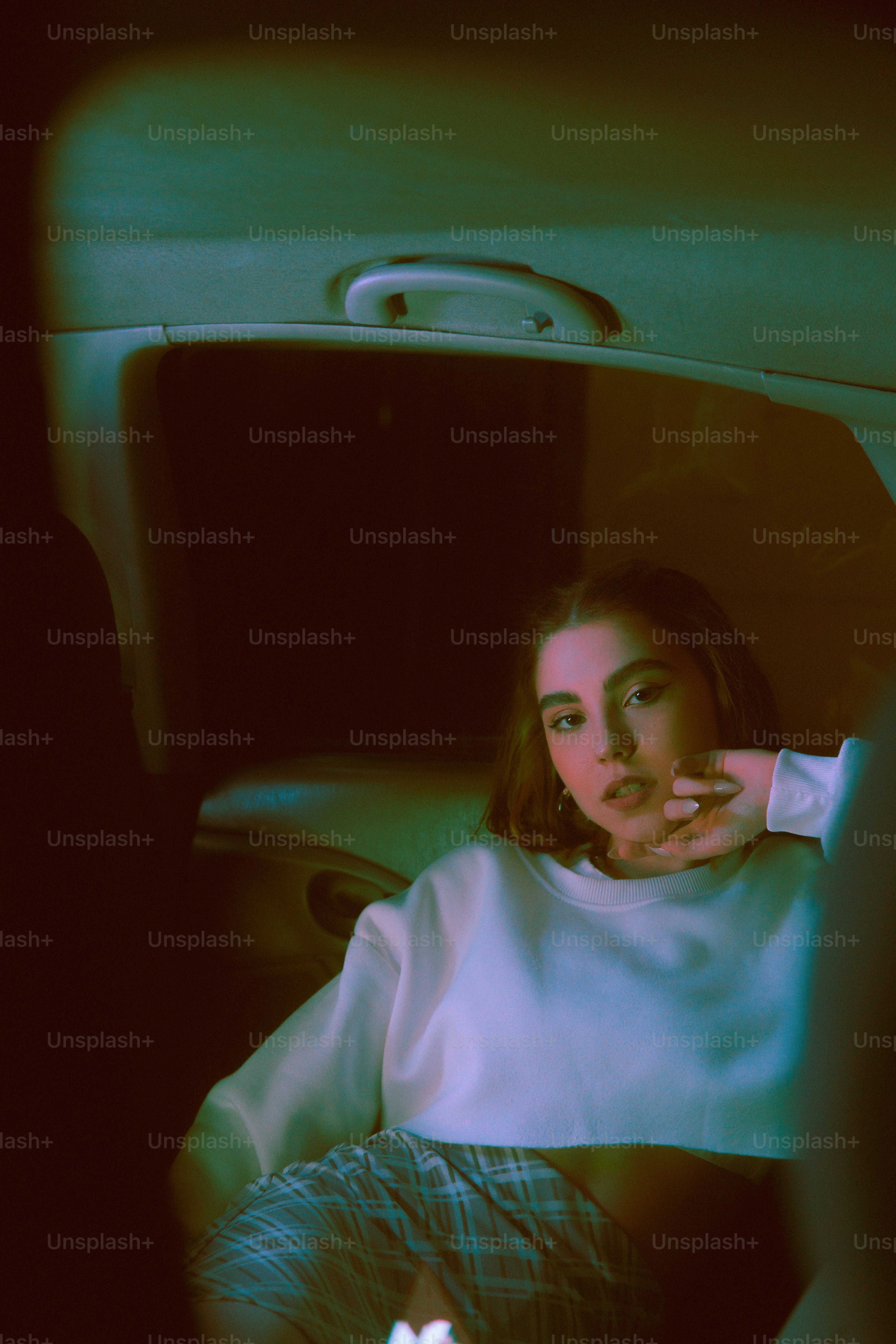 Una mujer sentada en la parte trasera de un coche