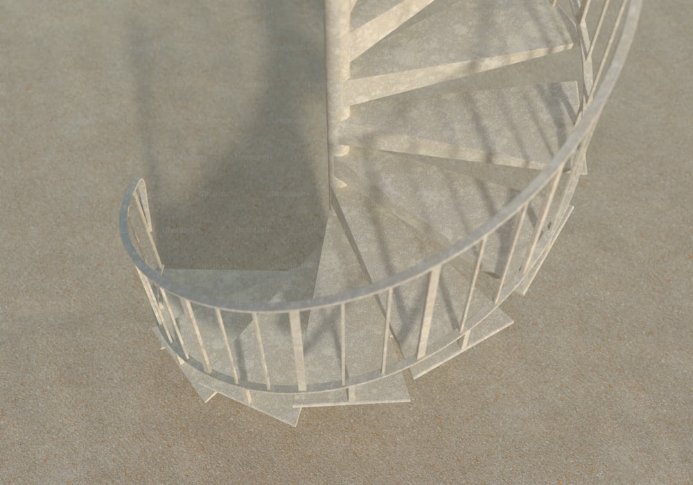 a white spiral staircase in the middle of a sandy area