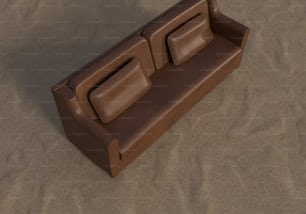 um sofá marrom sentado em cima de uma praia de areia