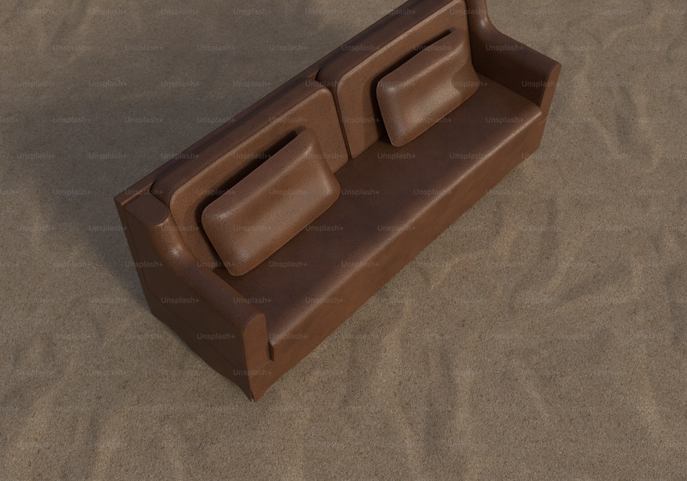 a brown couch sitting on top of a sandy beach