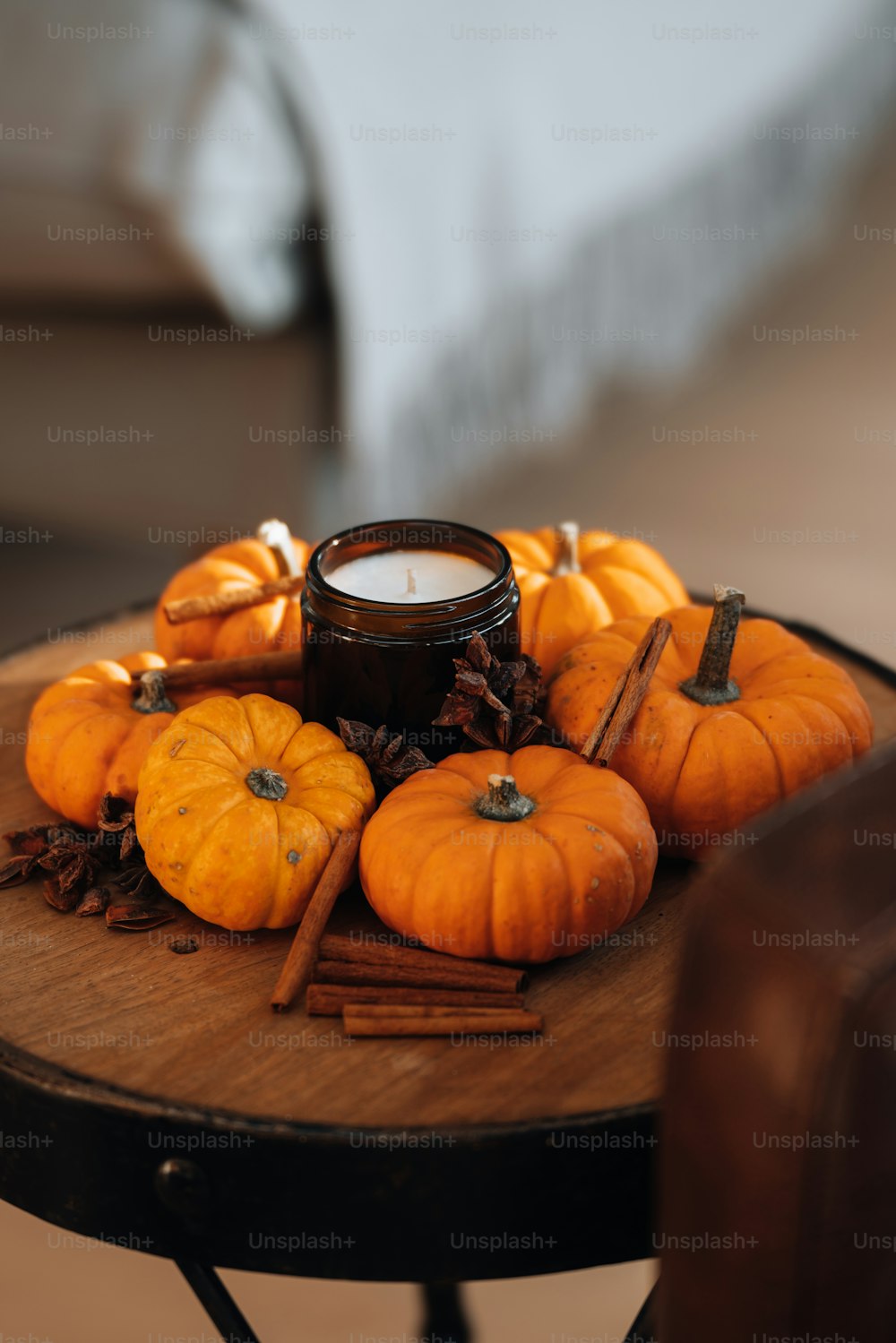 a wooden table topped with lots of orange pumpkins