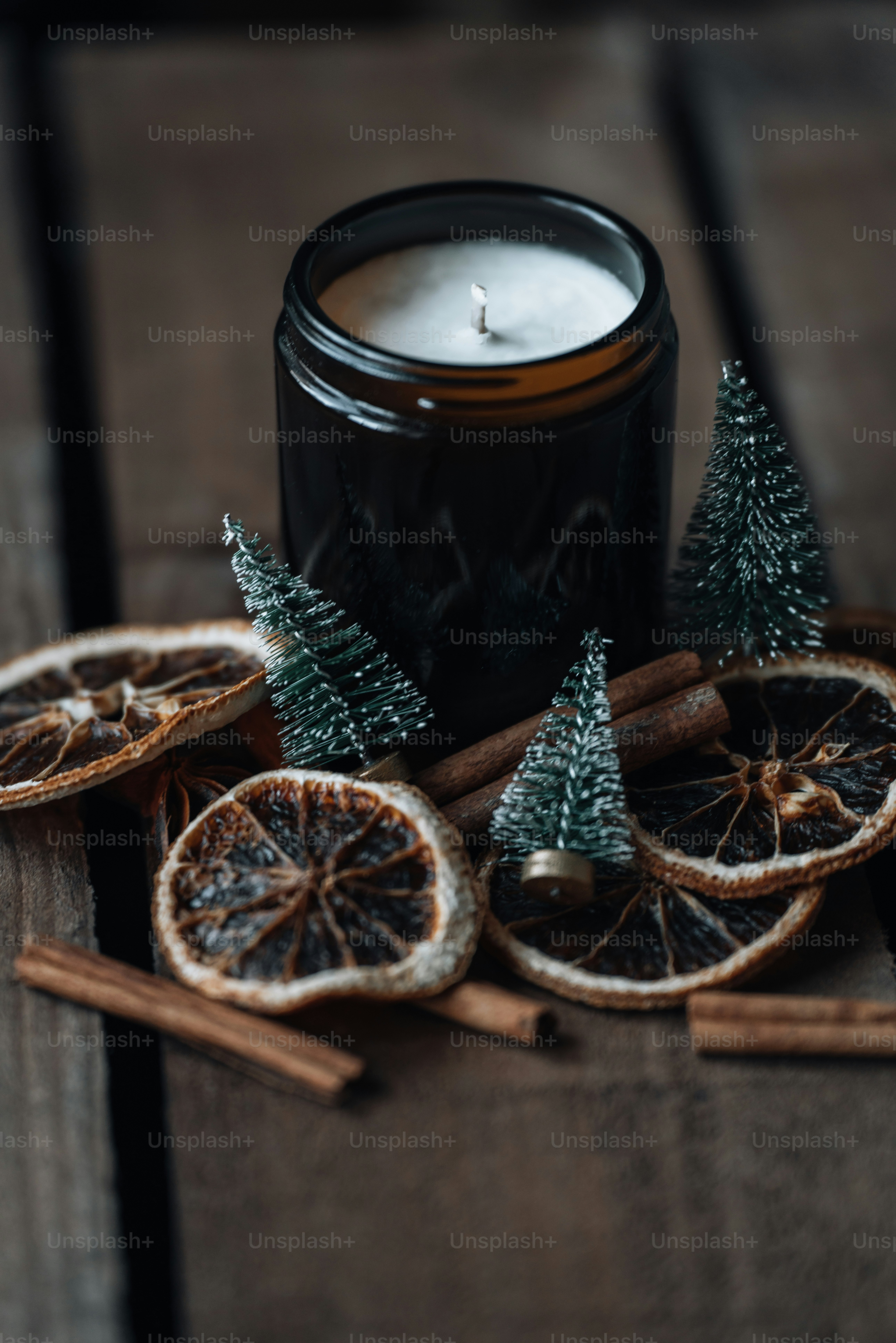 a candle and some cinnamons on a table