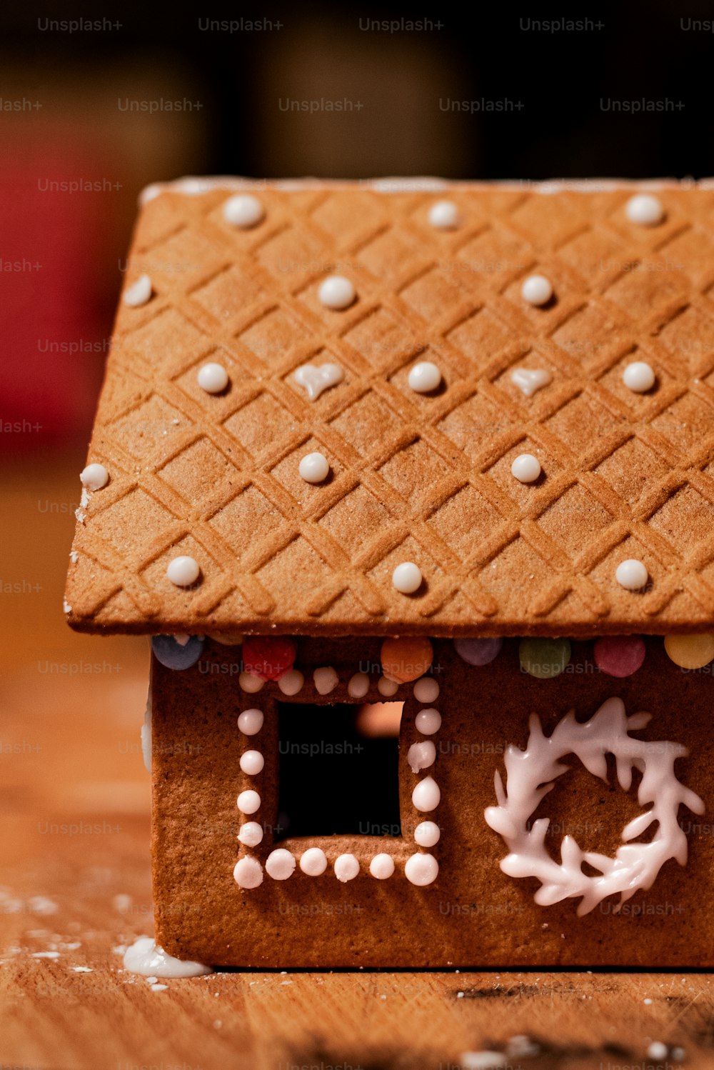 a gingerbread house with white decorations on it