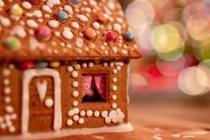 a close up of a gingerbread house on a table