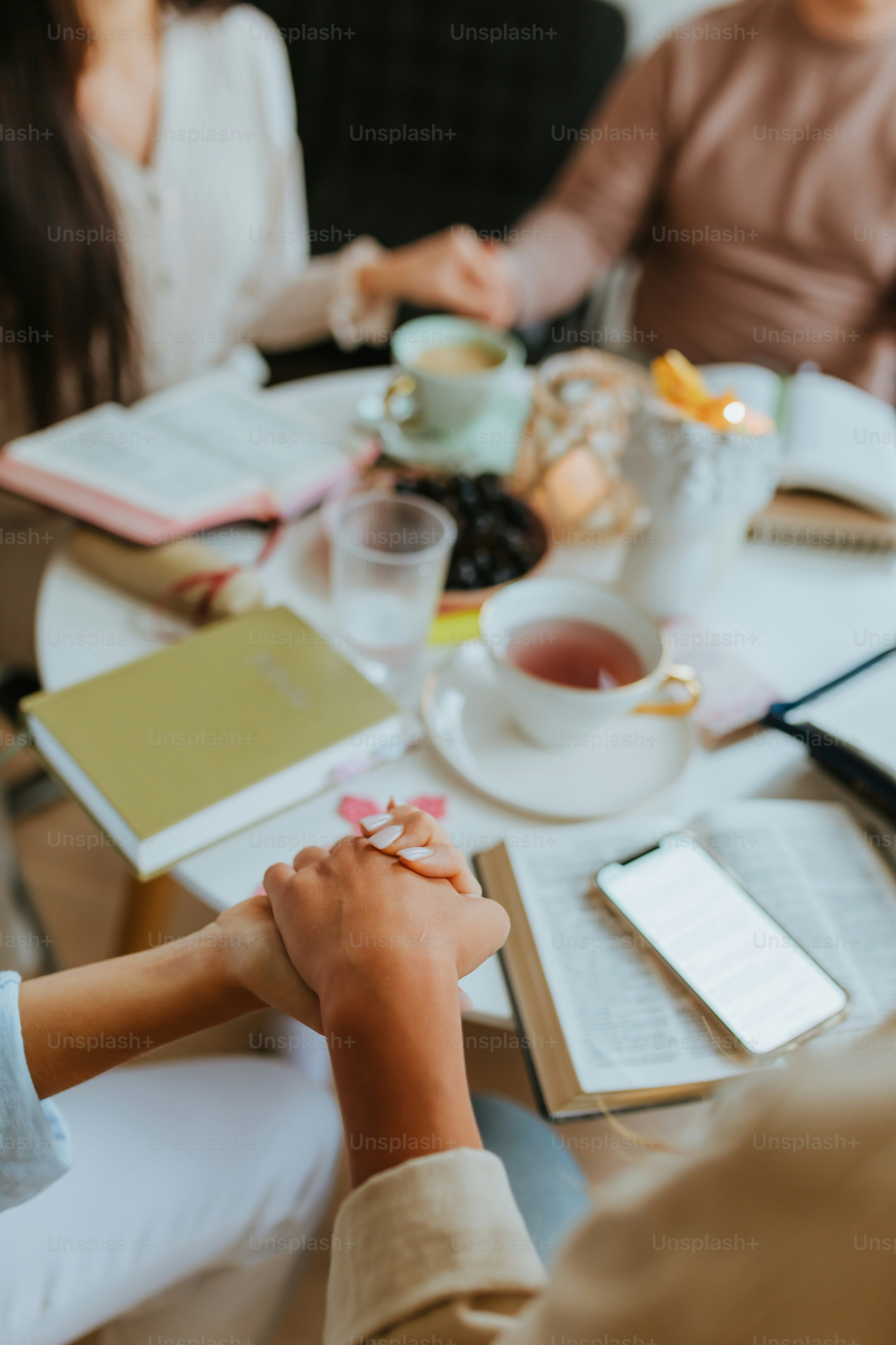 a group of people sitting at a table with food and drinks