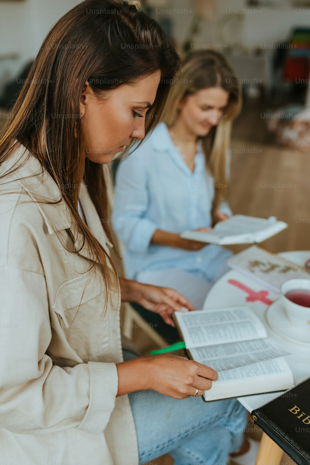 a few women looking at a book