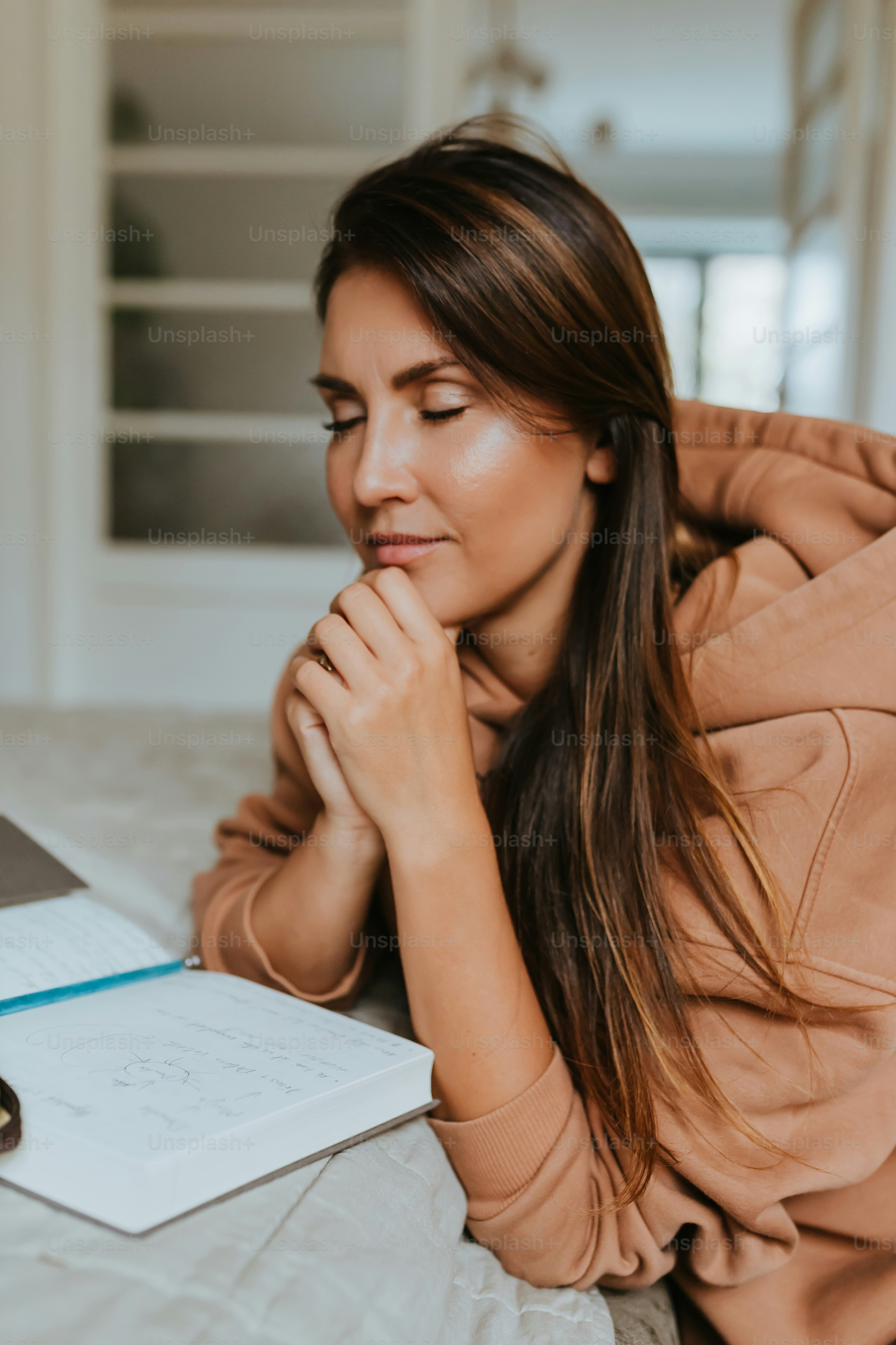 a woman with her hand on her chin