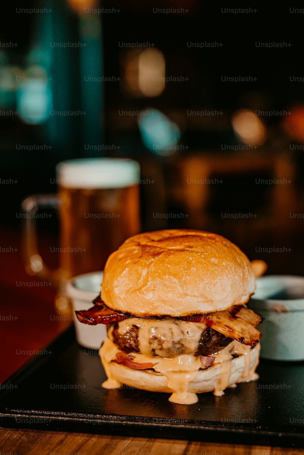 a burger with bacon and cheese on a tray