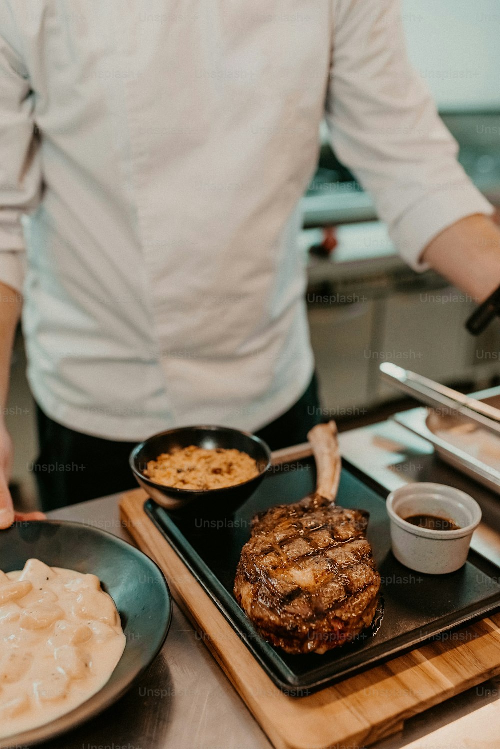 a man preparing food in a kitchen on a cutting board