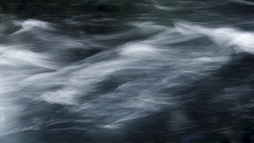 a black and white photo of water and clouds