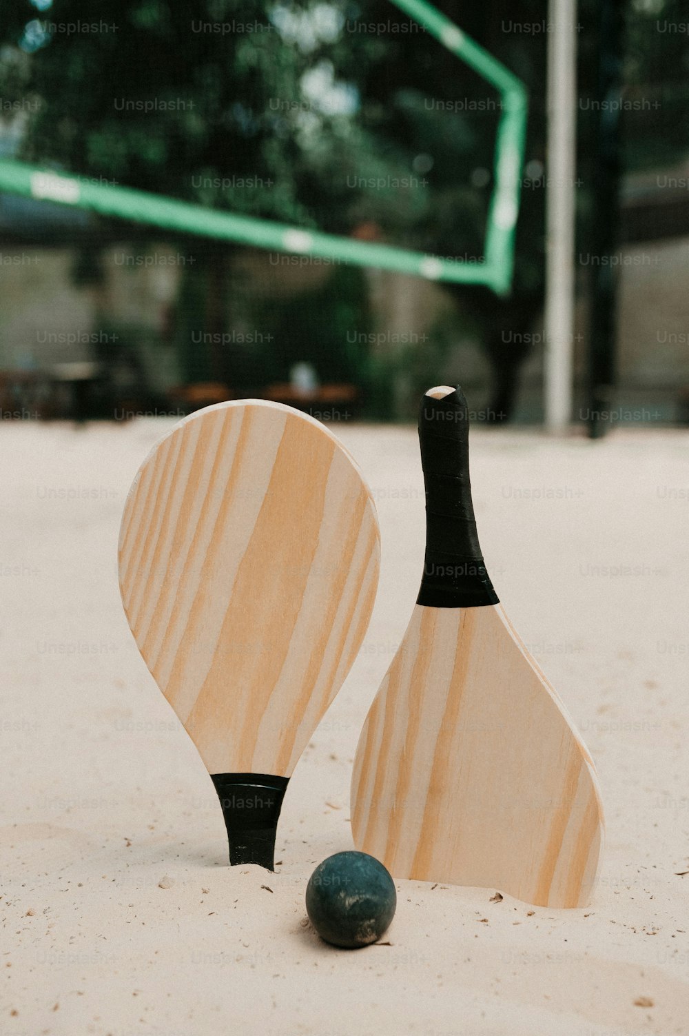 a couple of paddles sitting on top of a sandy beach