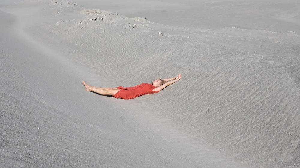 a man is laying down in the sand